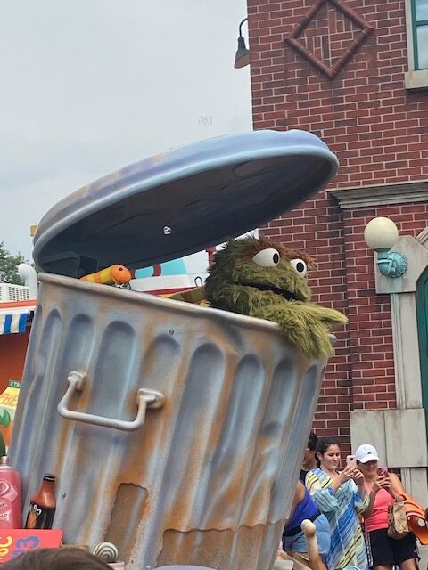 At Sesame Place theme park, Oscar the Grouch peeks out of his trash can. 