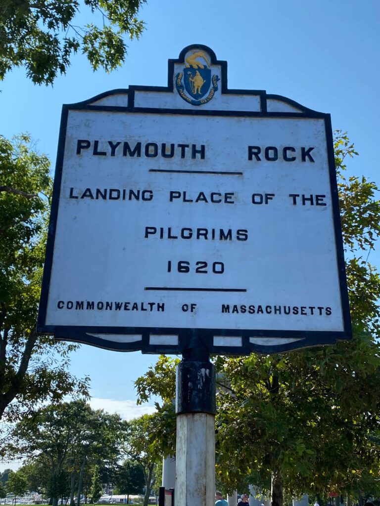 A plaque that reads, " Plymouth Rock- Landing place of the Pilgrims 1620-Commonwealth of Massachusetts