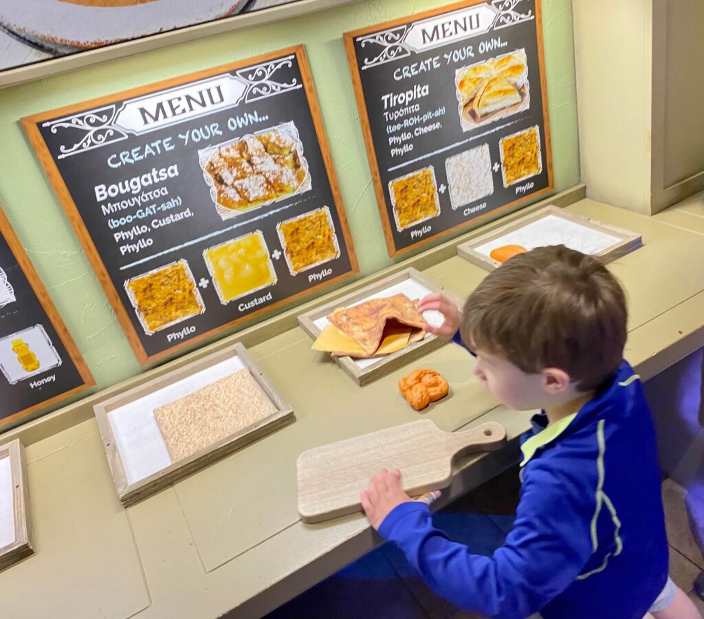 A child looks at Grecian recipes to make a meal of pretend food at the Childrens Museum of Indianapolis. 