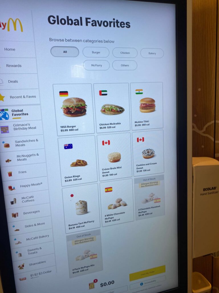 The Global Favorites menu at the Chicago McDonalds, Hamburger University location.  The menu features flags of the nations where the pictured menu items are available. 