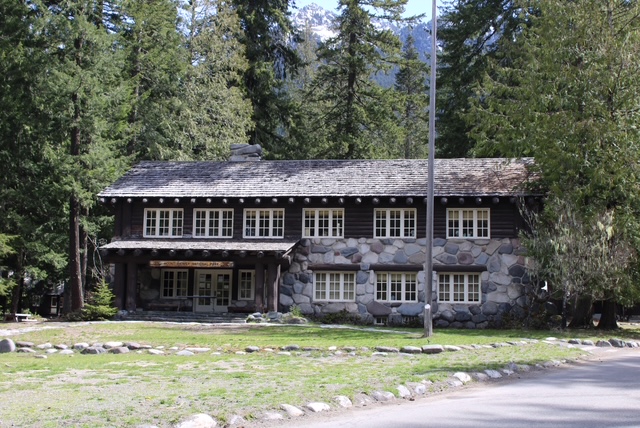 The administration building at Mount Rainier National Park.  A long house with 6 windows along the front of the second floor.  Part of the first floor is made of stone. 