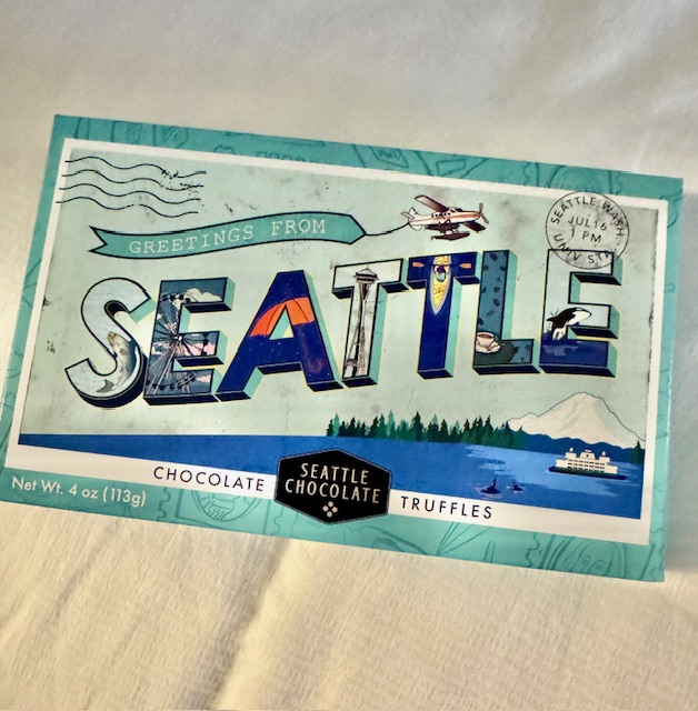 A box of chocolates is designed to look like a postcard for Seattle. 