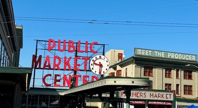 Large red letters read, "Public Market Center" with a clock. This is the famous landmark of Seattle's Pike Market. 