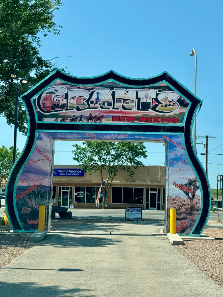 An Interstate symbol, large enough to drive through, with Grants painted on the top and dessert designs painted on it as well.  