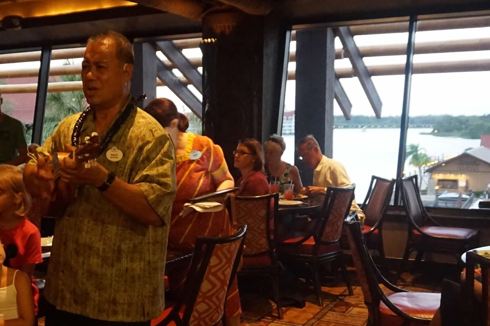 A man plays the ukulele in the Ohana restaurant. 