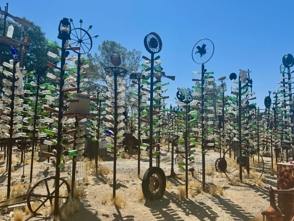 In the desert stands rows upon rows of "trees" made of glass bottles.  They are over 6 feet tall and some have weather vanes as toppers- this is Elmer's Bottle Tree Ranch.