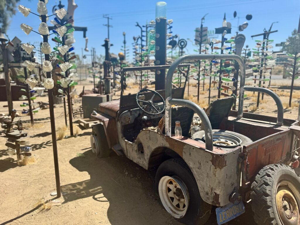 An old dilapidated jeep sits amongst bottle trees at Elmer's Bottle Tree Ranch.  